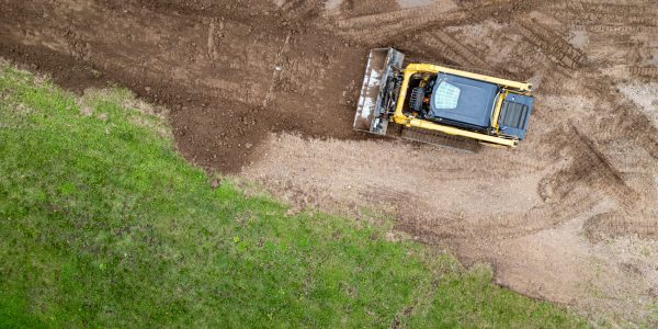 Drone,Photo,Of,Skid,Steer,Clearing,And,Leveling,Land